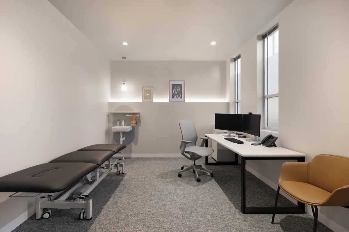 Consultation room at Hunter Blood Group with desk and examination bed
